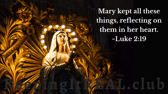 Image of a statue of the Virgin Mary with lights around her head.